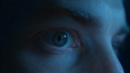 Close-up of a man wide-open eyes staring continuously at the screen in fear and astonishment. Addiction to social media, digital dependence and mindlessly doomscrolling - Powered by Adobe