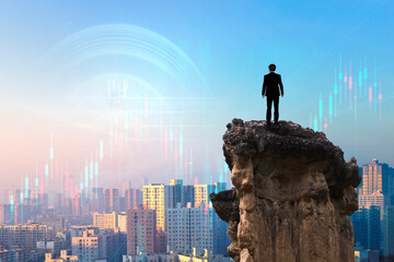 Businessman standing on edge of cliff over cityscape and forex chart