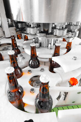 Automated beer bottling in modern brewery factory with machinery