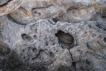 Hollows and alveoli formed by wind erosion in the granite cliffs