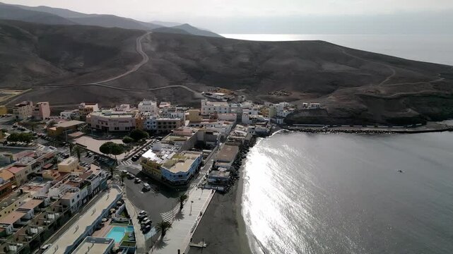 Aerial view of the Tarajalejo, town situated on the slopes of volcanic coast of the southern part of the Fuerteventura Island, Canary Islands, Spain.