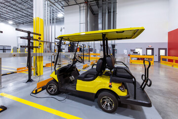 Electric golf cart in charging station inside warehouse  © Francisco