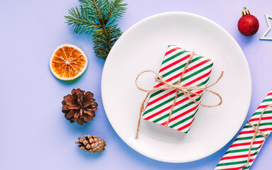 Christmas table setting for christmas dinner, served table with plate, gift, champagne glass, New year decorations. Flat lay, top view