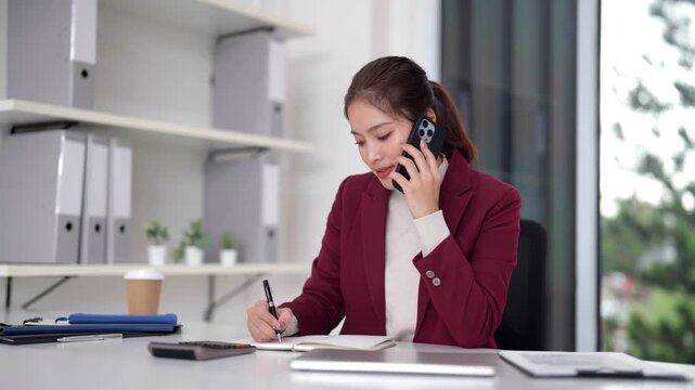 Asian adult businesswoman working laptop office desk professional focused tasks modern workspace indoor environment productive technology solutions