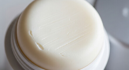 Macro Close-Up of Solid White Deodorant Stick Surface Texture
An extreme close-up, high-angle macro photograph focusing on the rounded, creamy white surface of a solid stick deodorant or antiperspiran