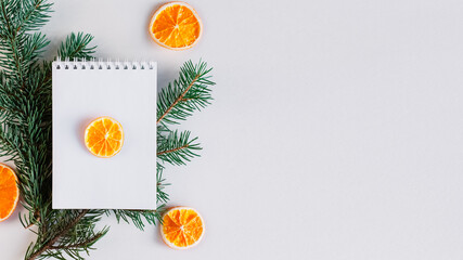 Blank open notebook mock up, to do list, wishlist for Santa, New year and Christmas goals. Christmas eve branch, dried orange, gift. Flat lay, top view, place for text