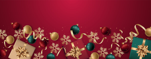 Festive arrangement of gifts and ornaments on rich red backdrop for celebrations. Web banner.