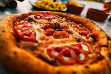 Italian Pizza with Tomatoes, Pepper, green Olives, Oregano and Mozzarella Cheese close up. Fresh Homemade Vegetable Pizza.