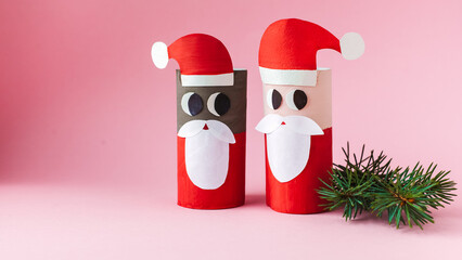 Christmas toy from toilet tube roll, paper toy santa claus, snowman, reindeer, tree rabbit on yellow background. Holiday easy kids DIY, decoration idea for winter season, home party. Children's crafts
