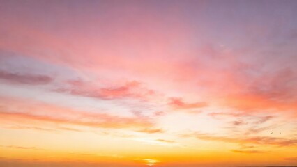 Fototapeta premium Sky painted with soft pastel clouds at sunrise and sunset.