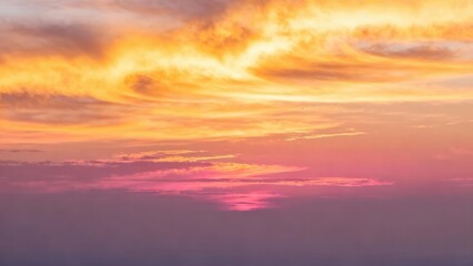 Fototapeta premium Vivid sunset sky displays swirling orange, pink, and purple clouds.