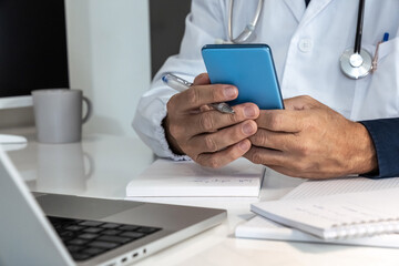 Doctor engaging with a smartphone in a modern medical setting, seamlessly integrating digital tools into patient care