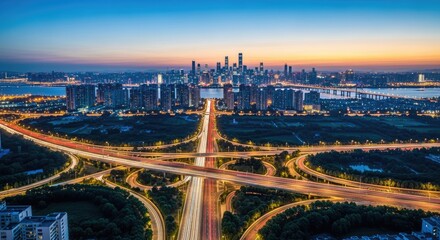 Aerial View of Cityscape with Overpass Traffic Trails at Twilight