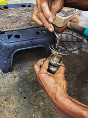 Clogged sink pipe in hands ,A plumber cleans a clogged siphon pipe of a sink in the kitchen. Clogged rusty water trap siphon and drainage pipe cleaning. Home plumbing maintenance service. DIY concept