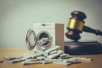 Washing machine is cleaning many US dollar bill banknotes with hammer judge gavel background. Money laundering from scam, criminal activity, corruption, etc. or law and enforcement concept.