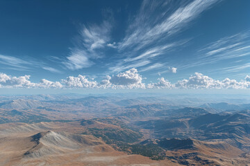 Fototapeta premium Majestic mountain range under vast blue sky with wispy clouds