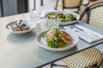 Gourmet meal with fresh salad served on a table in a chic restaurant setting during lunch hour