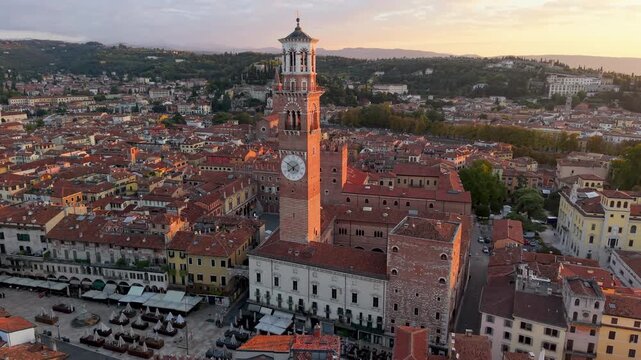 historic rooftops illuminated at dusk, dusk colors cast warm light on centuriesold riverfront. Verona. Italy