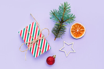Obraz premium Collection of Christmas objects - gift box, frame, eve fir, dried orange, pine cone, star. New Year and winter minimal holiday frame composition. Flat lay, top view, place for text.