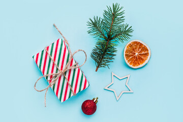 Obraz premium Collection of Christmas objects - gift box, frame, eve fir, dried orange, pine cone, star. New Year and winter minimal holiday frame composition. Flat lay, top view, place for text.
