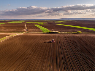 Tractor seeding field, drone aerial view farming landscape