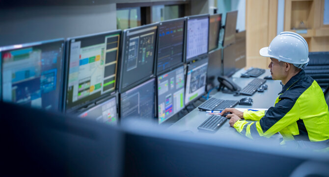 Engineer working at control room, Manager control system, Technician man monitoring program from a lot of monitor.
Specialist observes analytics dashboard,operator inspects digital interface