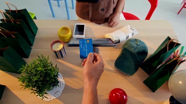 Close-up 4K Ultra HD footage of a customer making a credit card payment at a retail store checkout, showing contactless transaction, modern shopping experience, and consumer lifestyle.