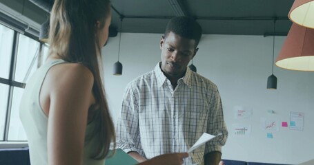 Reviewing documents man in plaid shirt consulting with teenage girl in modern office, sticky notes