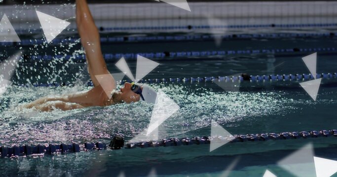 Performing male swimmer backstroking in competition pool, with goggles swim cap and lane ropes - Powered by Adobe