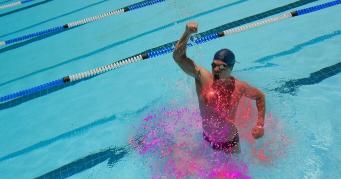 Emerging swimmer thrusting right fist up in outdoor lap pool wearing swim cap, goggles, copy space