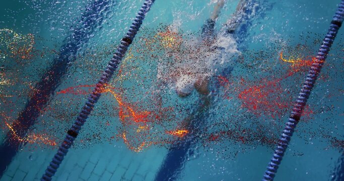 Swimming man pushing through aquatic center pool, with dark blue lane ropes and bubbles