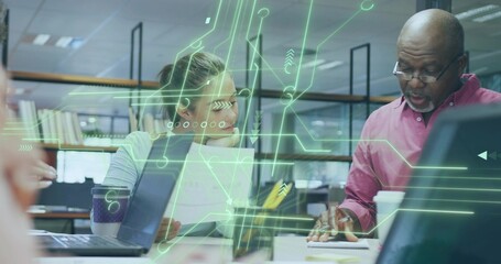 Collaborating woman and man reviewing paperwork and laptops in office, circuit overlay, copy space