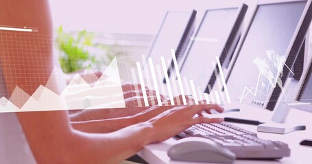 Typing forearms and hands pressing keyboards at office workspace, with monitors and data overlays