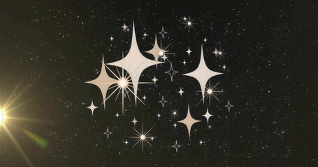 Fototapeta premium Shining stylized starbursts hovering in outer space among scattered stars, with bright lens flare