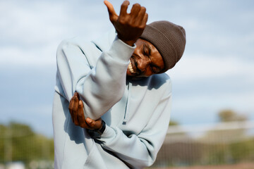 Male athlete cries out in agony, intensely holding his injured elbow or arm while experiencing acute pain during a training session break