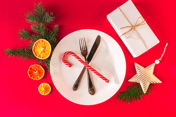 Christmas table setting for christmas dinner, served table with plate, gift, champagne glass, New...