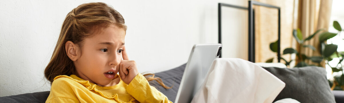 Engaging in digital exploration at home, a Gen Alpha girl enjoys her casual day