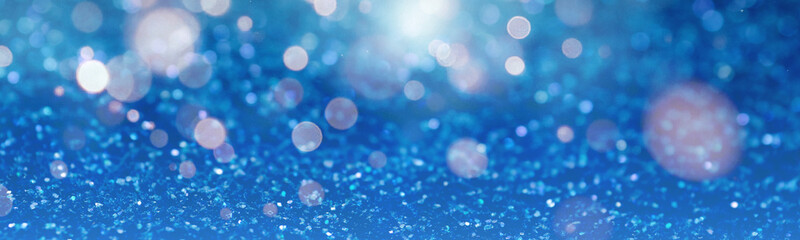 Christmas background with blue glitters and bokeh lights. Banner design