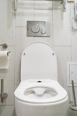 Fototapeta premium White toilet bowl with toilet accessories