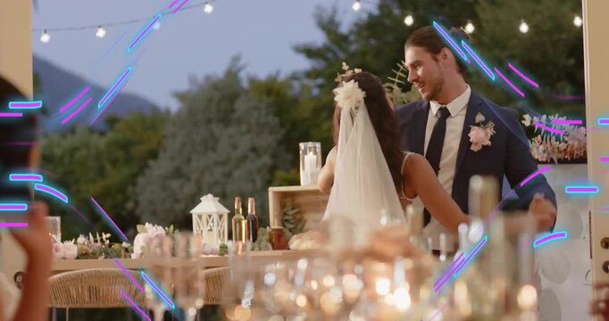 Gentle music starting, bride and groom dancing first dance at wedding reception under string lights