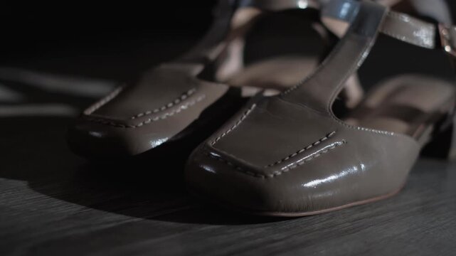 Close-up of women's beige patent leather shoes