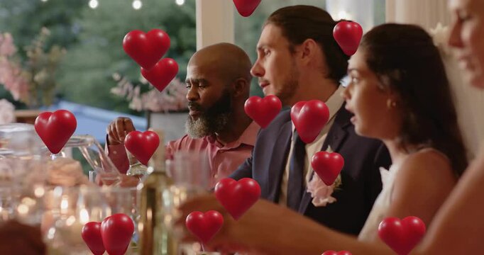 Wedding guests raising flutes after toast speaker prompt, celebrating union with floating hearts