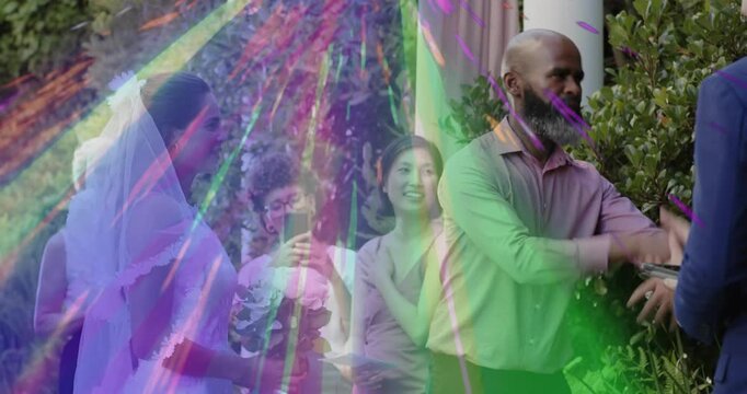 officiant reaching forward lifting veil over bride in wedding, revealing face with animated petals