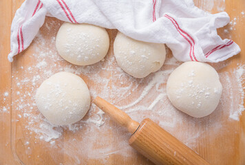Pieces of raw bread dough  on wooden kitchen table, baking bread or pizza