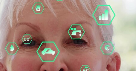 Senior woman gazing and exploring AR green data with pulsing CO?, electric car, water droplet icons - Powered by Adobe