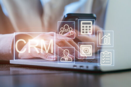 Using CRM software on a laptop for managing customer relationships in a modern office setting - Powered by Adobe