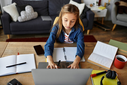 Casual girl happily exploring creative projects at home in her comfortable space