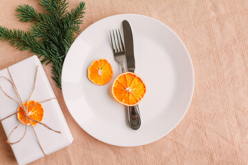 Christmas table setting for christmas dinner, served table with plate, gift, champagne glass, New year decorations. Flat lay, top view