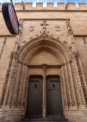 VALENCIA, SPAIN – NOVEMBER 1, 2025: Tourism accommodation sign displayed on the historic facade of the Silk Exchange (Lonja de la Seda) in Valencia, Spain, highlighting the impact of overtourism on he