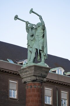 Lurspieler, antique trumpets, bronze sculpture on terracotta column, Town Hall Square, Rathausplatz or R&aring;dhuspladsen, Copenhagen, Denmark